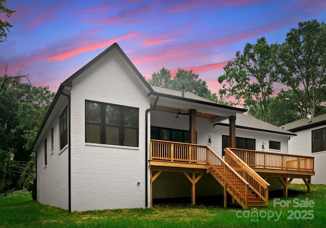 1622 Burtonwood Cir, Charlotte, NC 28212 - back of house at dusk with stairs, ceiling fan, brick siding, and a deck