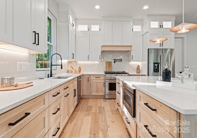 1622 Burtonwood Cir, Charlotte, NC 28212 - kitchen with high end appliances, light wood-type flooring, light brown cabinetry, recessed lighting, and light stone countertops