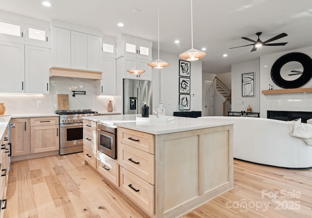 1622 Burtonwood Cir, Charlotte, NC 28212 - kitchen featuring premium appliances, light wood-style flooring, recessed lighting, open floor plan, and decorative backsplash