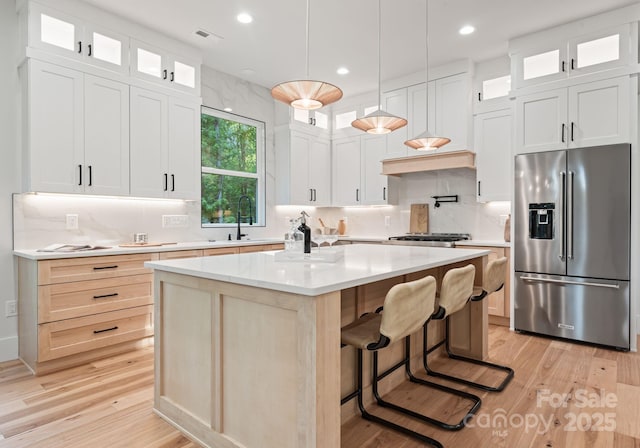 1622 Burtonwood Cir, Charlotte, NC 28212 - kitchen with high end refrigerator, backsplash, light wood finished floors, a center island, and recessed lighting