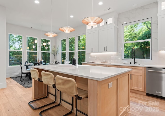 1622 Burtonwood Cir, Charlotte, NC 28212 - kitchen with dishwasher, a center island, light wood-style floors, light countertops, and recessed lighting