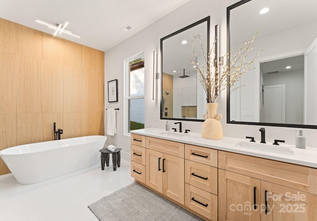 1622 Burtonwood Cir, Charlotte, NC 28212 - bathroom with double vanity, a freestanding bath, walk in shower, recessed lighting, and tile walls