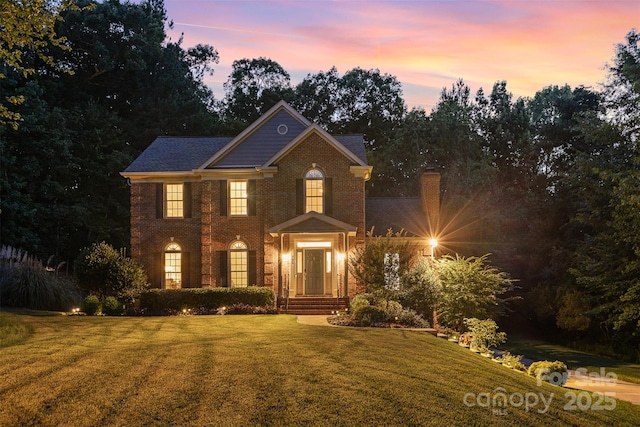 205 Rosedale Ln, Matthews, NC 28105 - georgian-style home featuring a lawn and brick siding