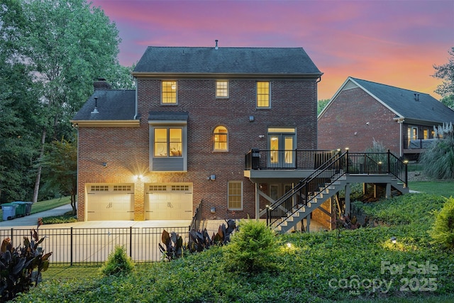 205 Rosedale Ln, Matthews, NC 28105 - back of property with stairway, brick siding, a wooden deck, a garage, and concrete driveway