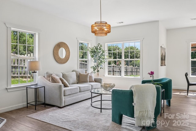 1986 Trace Creek Dr, Waxhaw, NC 28173 - living room with wood finished floors, healthy amount of natural light, and a chandelier