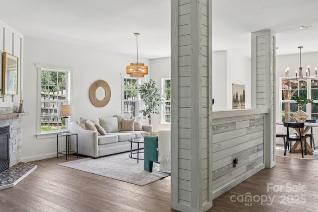 1986 Trace Creek Dr, Waxhaw, NC 28173 - living room with a chandelier, wood-type flooring, and a glass covered fireplace