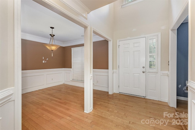 2001 Enderbury Dr, Indian Trail, NC 28079 - foyer entrance with a wainscoted wall, a decorative wall, light wood-style flooring, and ornamental molding