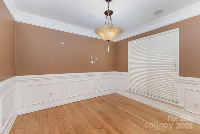 2001 Enderbury Dr, Indian Trail, NC 28079 - empty room with a wainscoted wall, ornamental molding, a decorative wall, and light wood-style flooring