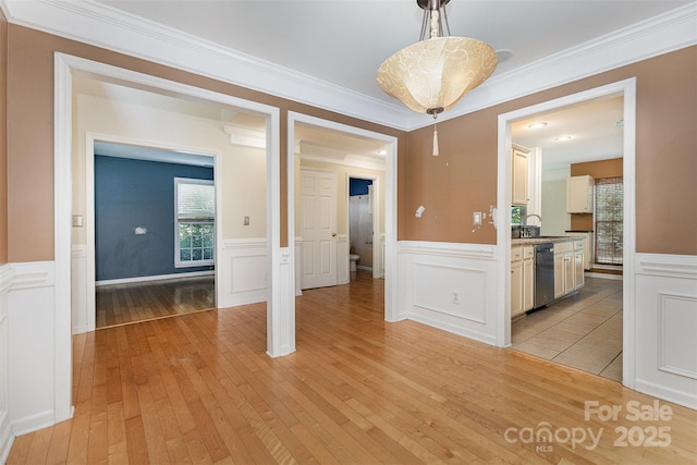 2001 Enderbury Dr, Indian Trail, NC 28079 - unfurnished dining area with light wood finished floors, a wainscoted wall, and a decorative wall