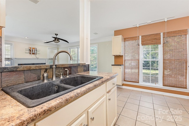 2001 Enderbury Dr, Indian Trail, NC 28079 - kitchen with light tile patterned floors, a ceiling fan, crown molding, white cabinetry, and open floor plan