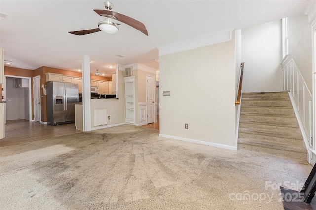 2001 Enderbury Dr, Indian Trail, NC 28079 - unfurnished living room with ceiling fan, light carpet, stairway, and ornamental molding
