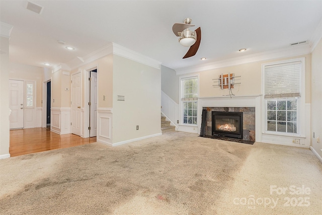 2001 Enderbury Dr, Indian Trail, NC 28079 - unfurnished living room featuring ornamental molding, carpet flooring, ceiling fan, a fireplace, and stairs