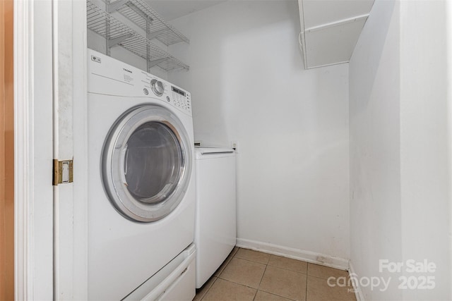 2001 Enderbury Dr, Indian Trail, NC 28079 - laundry room featuring light tile patterned floors, washing machine and dryer, and attic access