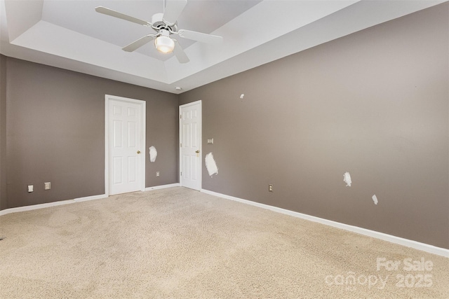 2001 Enderbury Dr, Indian Trail, NC 28079 - unfurnished bedroom with light carpet, a tray ceiling, ceiling fan, and a closet
