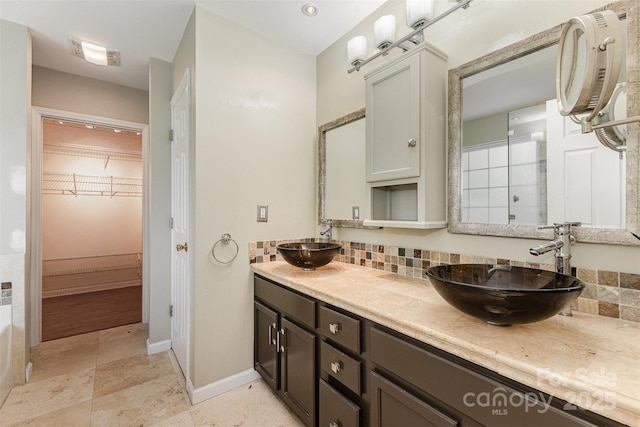 2001 Enderbury Dr, Indian Trail, NC 28079 - full bathroom with decorative backsplash, double vanity, and a spacious closet