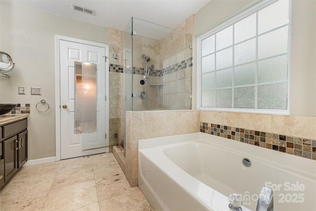 2001 Enderbury Dr, Indian Trail, NC 28079 - full bath featuring a bath, a stall shower, vanity, and plenty of natural light