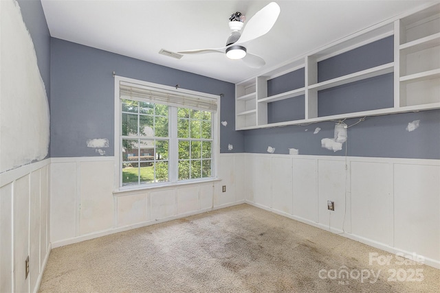 2001 Enderbury Dr, Indian Trail, NC 28079 - carpeted empty room featuring a wainscoted wall, a ceiling fan, and a decorative wall