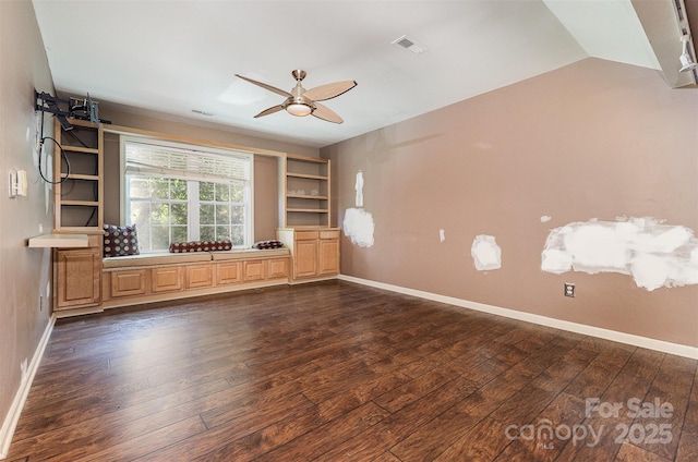 2001 Enderbury Dr, Indian Trail, NC 28079 - unfurnished living room featuring dark wood-type flooring, ceiling fan, built in features, and vaulted ceiling
