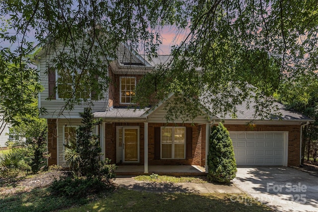 2001 Enderbury Dr, Indian Trail, NC 28079 - view of front of property featuring driveway, an attached garage, a porch, and brick siding