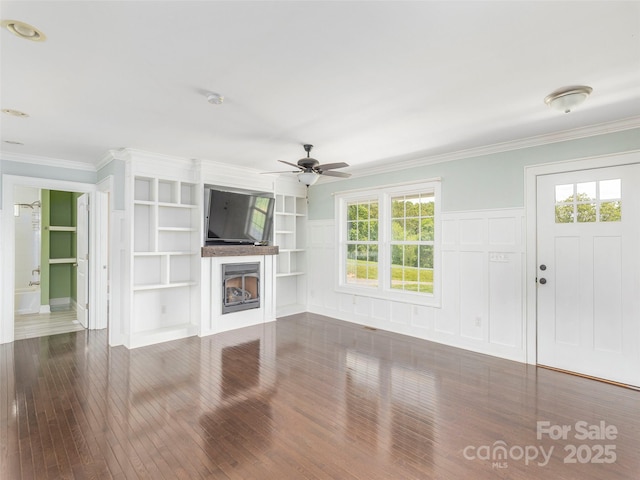 3355 Thickety Rd, Clyde, NC 28721 - unfurnished living room featuring wood-type flooring, ceiling fan, a fireplace, ornamental molding, and built in features