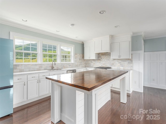 3355 Thickety Rd, Clyde, NC 28721 - kitchen with stainless steel appliances, wood counters, crown molding, backsplash, and white cabinets