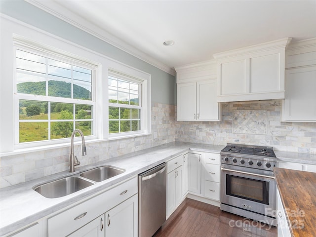 3355 Thickety Rd, Clyde, NC 28721 - kitchen featuring appliances with stainless steel finishes, wooden counters, white cabinets, dark wood finished floors, and tasteful backsplash