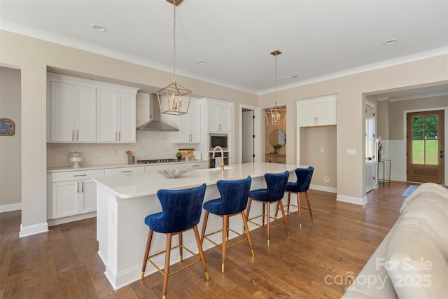 8680 Sherrills Ford Rd, Sherrills Ford, NC 28673 - kitchen featuring wall chimney exhaust hood, stainless steel microwave, gas stovetop, tasteful backsplash, and an island with sink