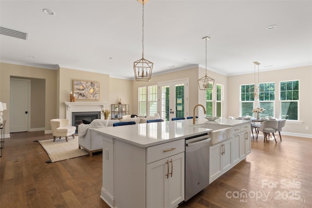 8680 Sherrills Ford Rd, Sherrills Ford, NC 28673 - kitchen with dishwasher, dark wood finished floors, a kitchen island with sink, a glass covered fireplace, and ornamental molding