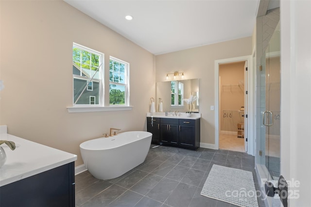 8680 Sherrills Ford Rd, Sherrills Ford, NC 28673 - bathroom featuring two vanities, a shower stall, a soaking tub, a walk in closet, and tile patterned flooring
