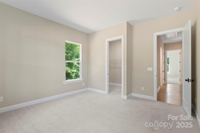 8680 Sherrills Ford Rd, Sherrills Ford, NC 28673 - unfurnished bedroom with attic access, light carpet, a spacious closet, and a closet