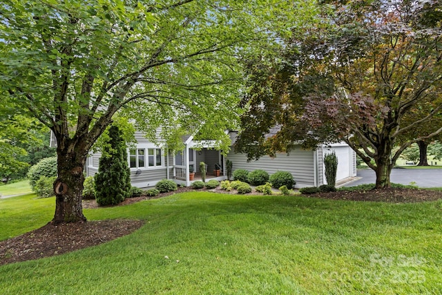 104 Overlook Dr, Flat Rock, NC 28731 - view of property hidden behind natural elements with a front lawn, driveway, and a garage