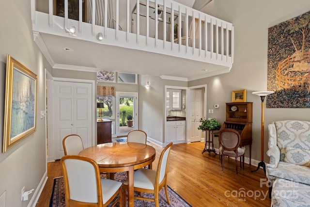 104 Overlook Dr, Flat Rock, NC 28731 - dining area featuring ornamental molding, light wood-type flooring, and a high ceiling