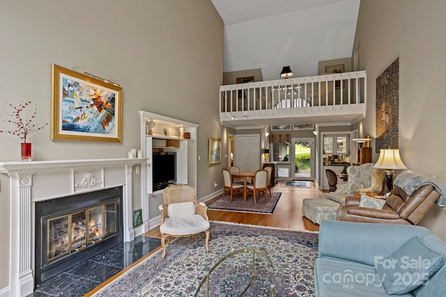 104 Overlook Dr, Flat Rock, NC 28731 - living area featuring a towering ceiling, wood finished floors, and a fireplace