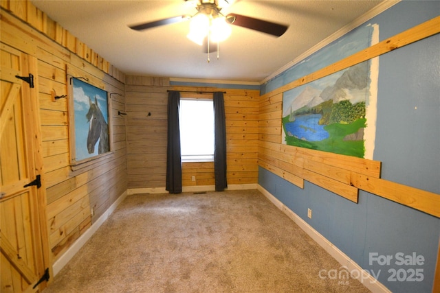 416 E Union St, Marshville, NC 28103 - carpeted empty room with a ceiling fan, wooden walls, and ornamental molding
