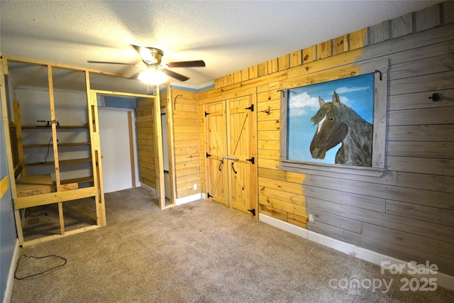 416 E Union St, Marshville, NC 28103 - unfurnished bedroom with wooden walls, carpet floors, a textured ceiling, and ceiling fan