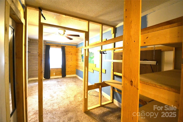 416 E Union St, Marshville, NC 28103 - unfurnished bedroom with carpet, wood walls, and a textured ceiling