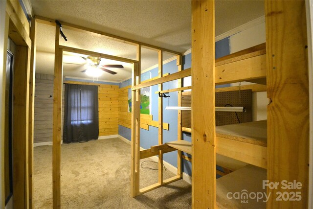416 E Union St, Marshville, NC 28103 - unfurnished bedroom featuring carpet flooring, a textured ceiling, and wood walls