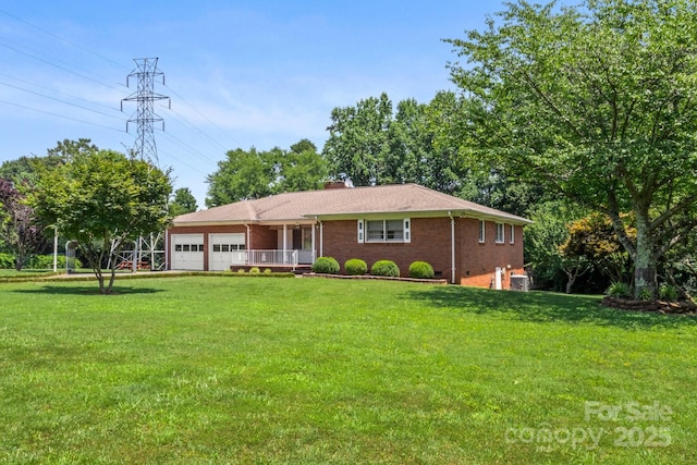 128 Howie St, Mount Holly, NC 28120 - ranch-style house with a garage, brick siding, a front lawn, and a chimney