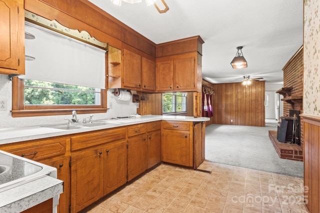 128 Howie St, Mount Holly, NC 28120 - kitchen featuring ceiling fan, light countertops, a peninsula, and wooden walls