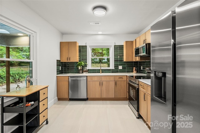 5320 Kildare Dr, Charlotte, NC 28215 - kitchen featuring appliances with stainless steel finishes, backsplash, and light countertops