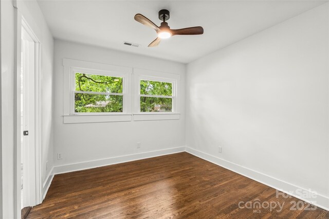 5320 Kildare Dr, Charlotte, NC 28215 - unfurnished bedroom featuring dark wood-type flooring and a ceiling fan