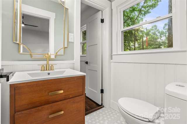 5320 Kildare Dr, Charlotte, NC 28215 - half bath featuring vanity, a decorative wall, and a wainscoted wall
