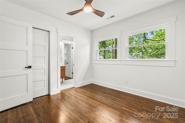 5320 Kildare Dr, Charlotte, NC 28215 - unfurnished bedroom featuring dark wood-style flooring, ensuite bathroom, and ceiling fan