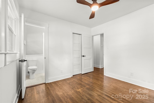 5320 Kildare Dr, Charlotte, NC 28215 - unfurnished bedroom featuring wood finished floors, ensuite bathroom, and a ceiling fan