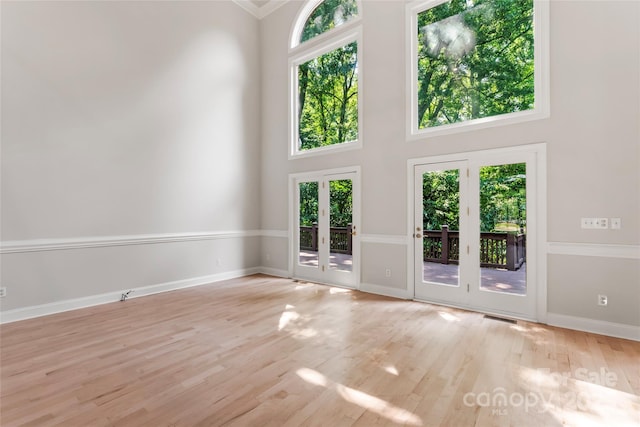 3011 Mckee Rd, Charlotte, NC 28270 - spare room with a towering ceiling, wood finished floors, french doors, and crown molding