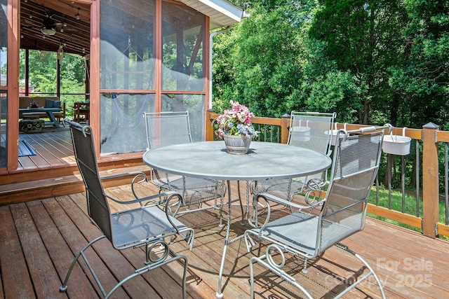5922 Sullins Rd, Charlotte, NC 28214 - deck with outdoor dining space, a sunroom, and a ceiling fan