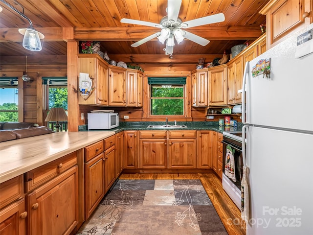 129 Melrose Lake Rd, Saluda, NC 28773 - kitchen with white appliances, a wood ceiling with exposed beams, dark wood finished floors, ceiling fan, and wood walls