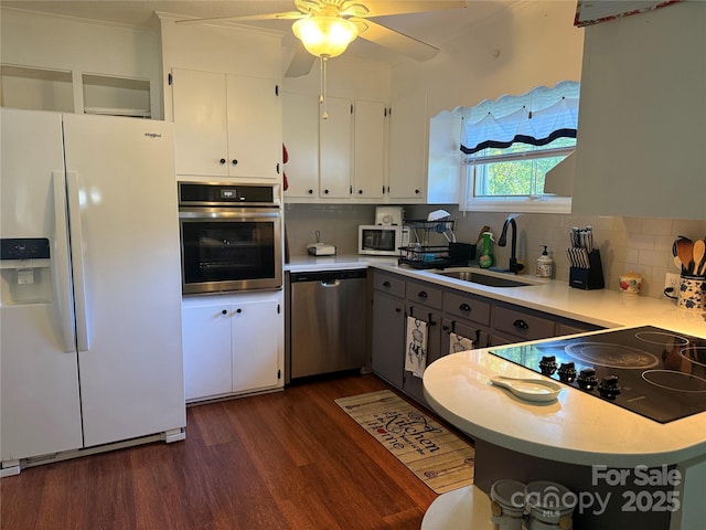 708 E St Unit 8, 9, Albemarle, NC 28001 - kitchen with appliances with stainless steel finishes, dark wood-style floors, a ceiling fan, white cabinets, and decorative backsplash