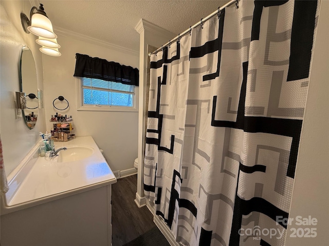 708 E St Unit 8, 9, Albemarle, NC 28001 - bathroom with vanity, ornamental molding, wood finished floors, a textured ceiling, and a shower with shower curtain