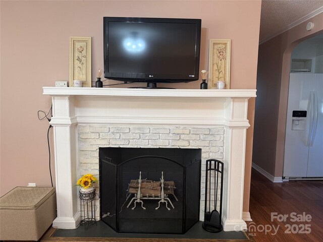 708 E St Unit 8, 9, Albemarle, NC 28001 - detailed view of white refrigerator with ice dispenser, wood finished floors, arched walkways, a fireplace, and crown molding